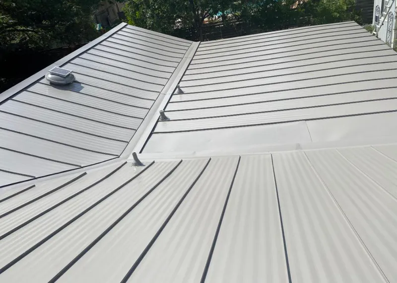 Solar attic fan installed on a metal roof for Roof Ventilation in Montrose